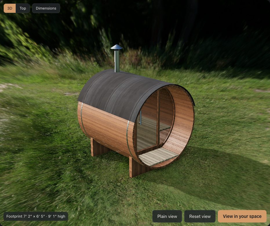 The barrel sauna demo: a red cedar barrel sauna with a covered porch and wood stove, on grass, in the 3D configurator.